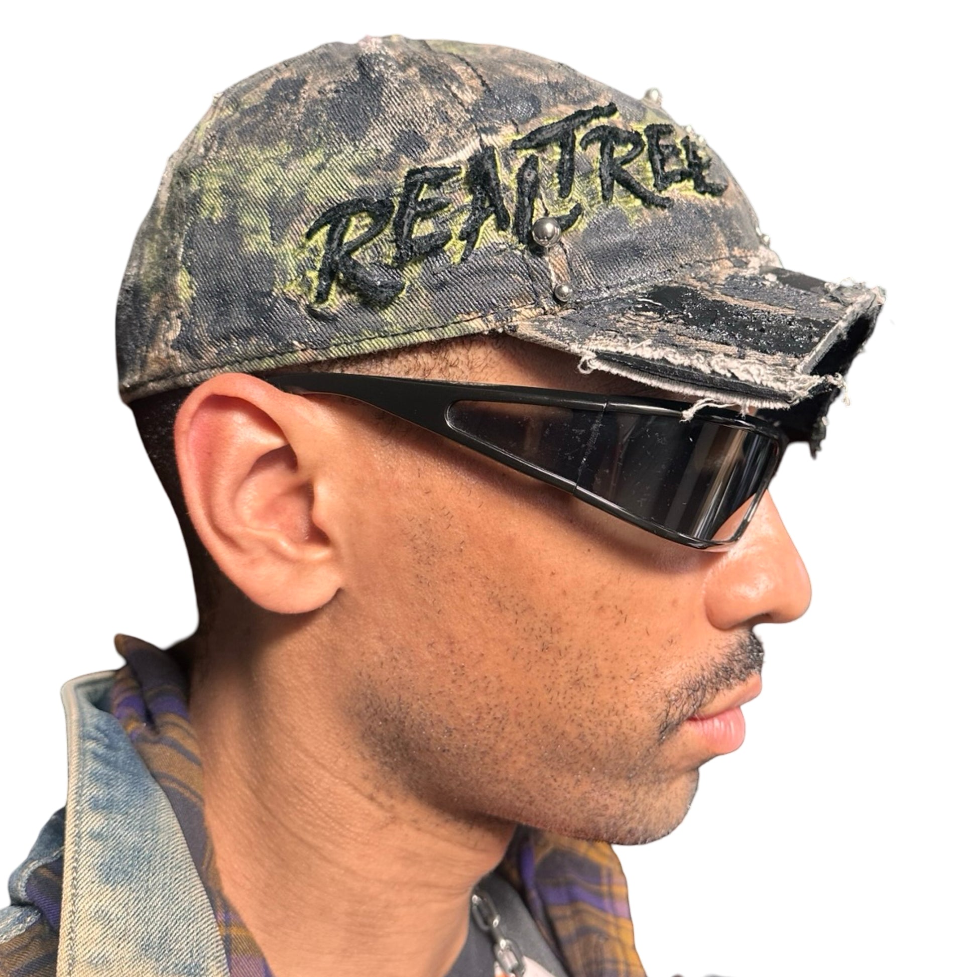 Right side of Brown RealTree distressed half-visor hat with elastic base, black resin detailing, and a sawed-off visor for a deconstructed Y2K aesthetic.