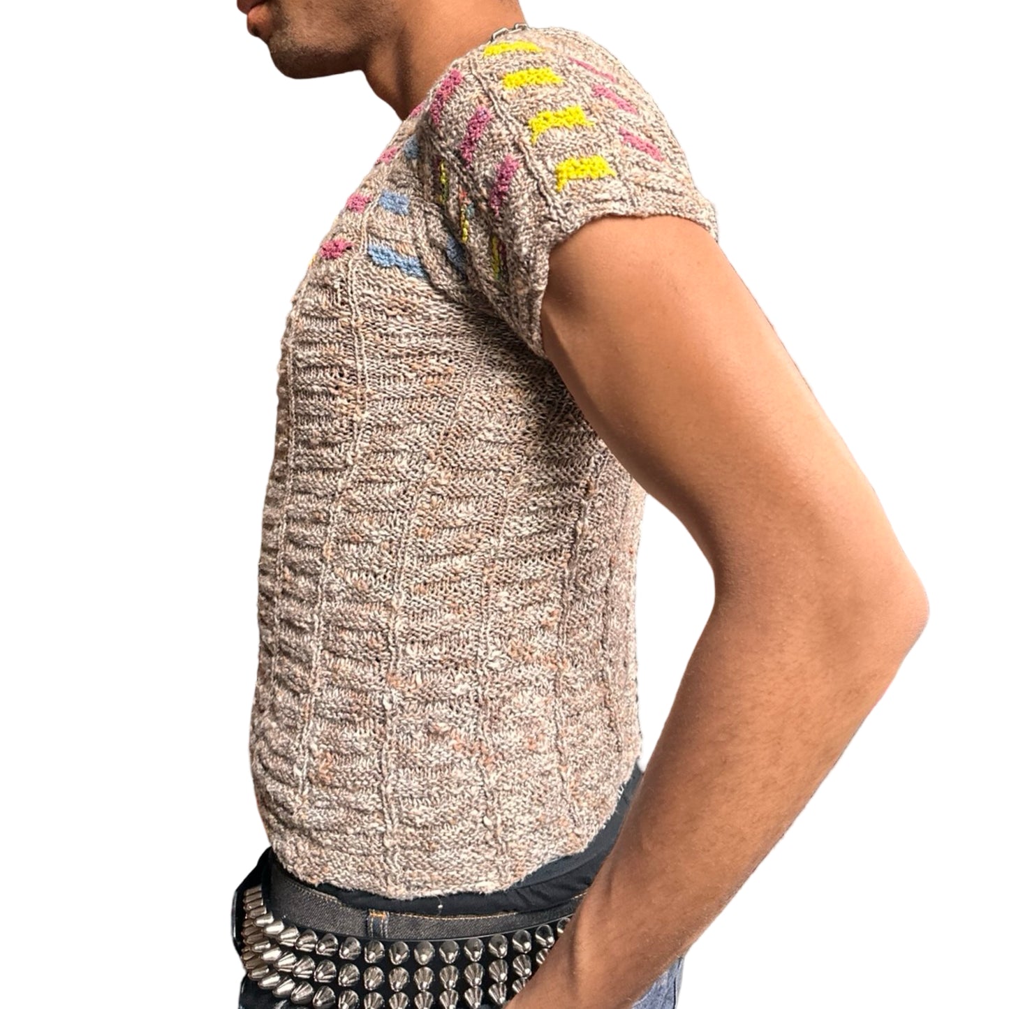 Vintage tan hand-knit speckled multicolored sweater with geometric stitching and wavy hemline, medium size. Left