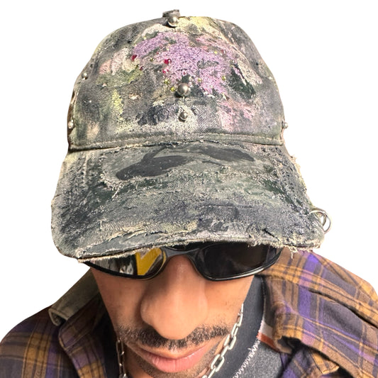 Front of Green distressed hat with metallic rhinestones sealed in resin and stainless steel piercings, customized by ASTROBOI*.