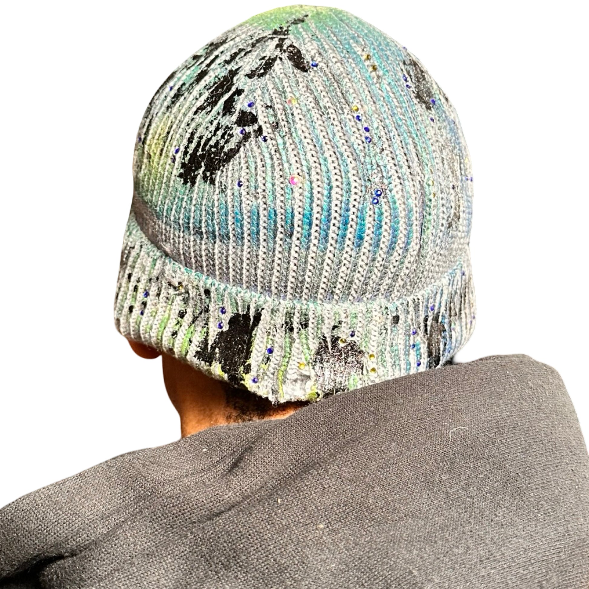 Back side of ASTROBOI* blue-green iridescent beanie featuring black metallic paint accents and tonal rhinestones, custom-made in NYC for a bold streetwear look.
