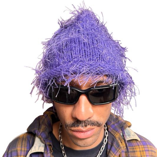 Front of Lavender purple eyelash-yarn knit beanie with rolled edges and a soft, textured silhouette. Stretchy, cozy winter hat.