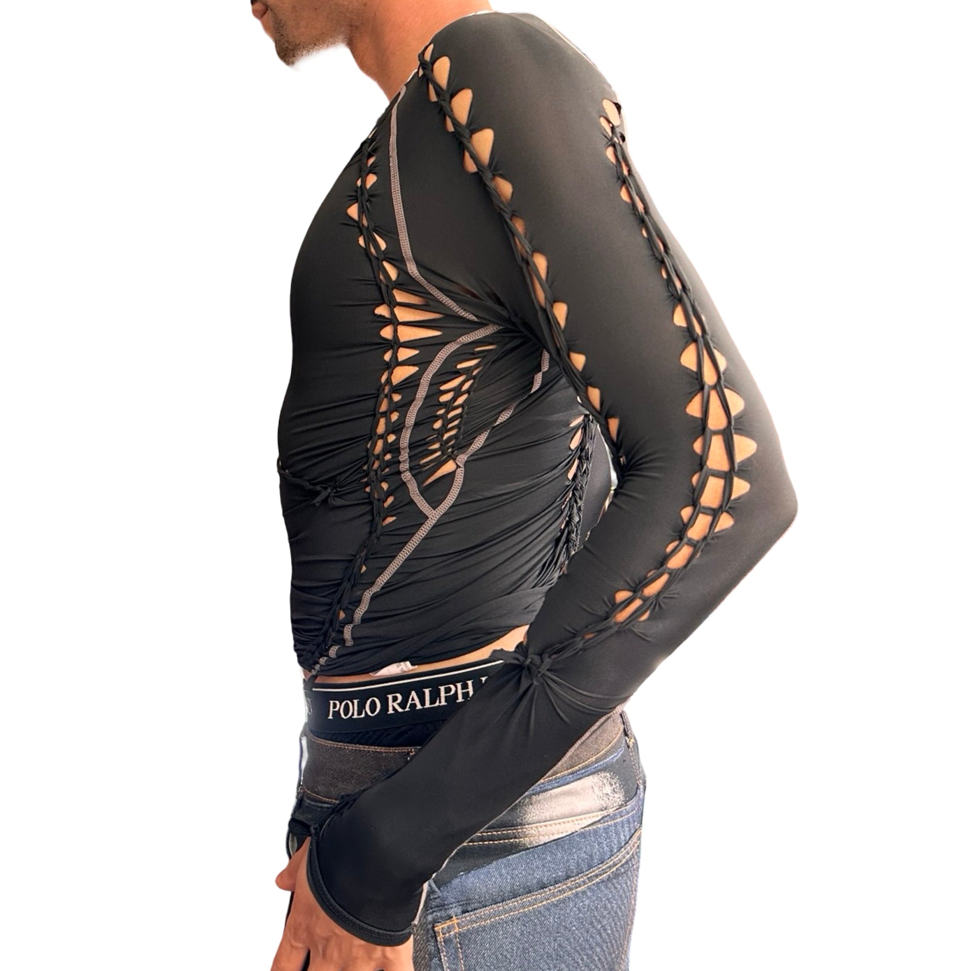 Left side of ASTROBOI* 'Mystique' black braided twist compression top with cut-out details. Handmade in NYC using breathable, moisture-wicking stretch fabric.