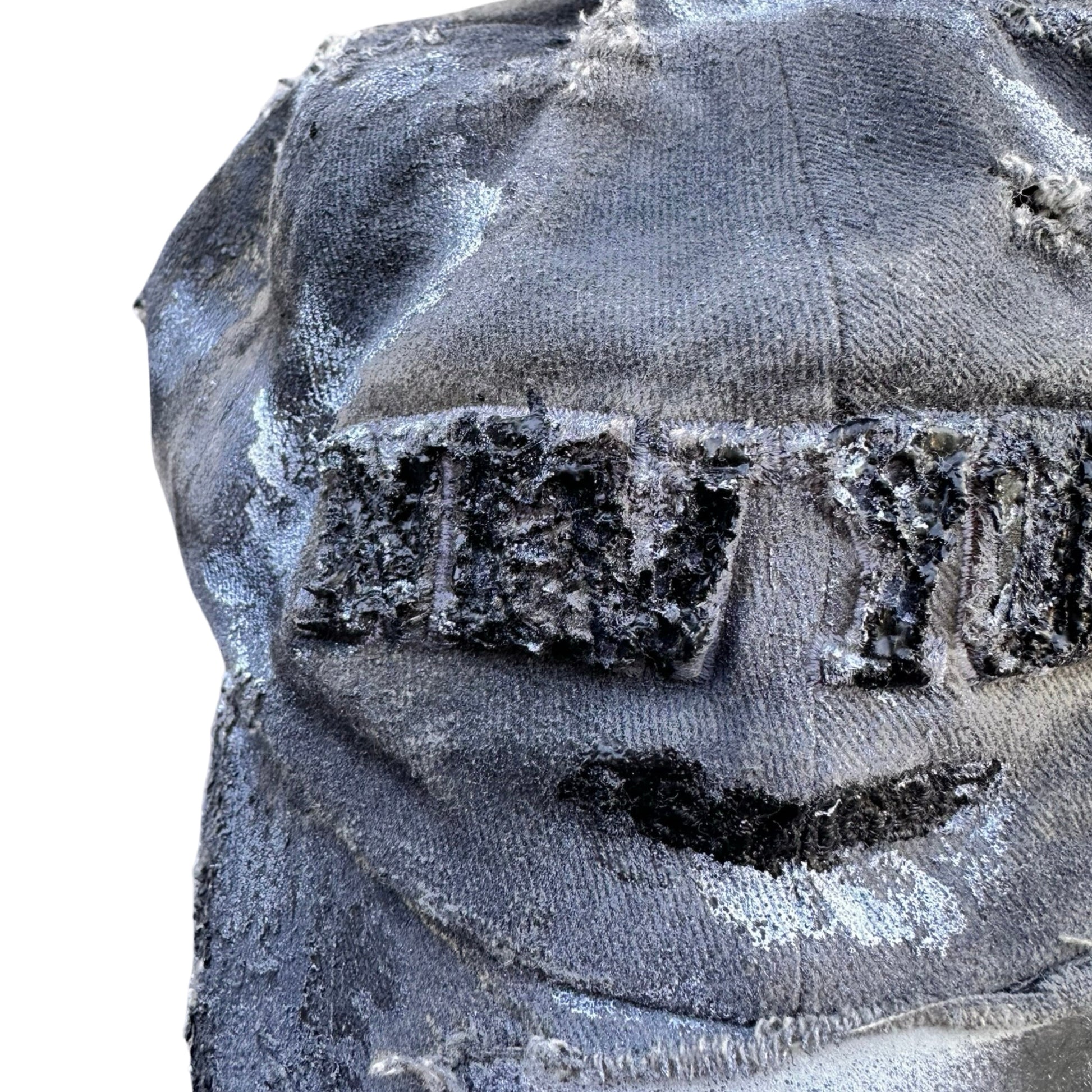 Flat close up image of ASTROBOI* tan and black New York logo hat with distressed half visor and black and white paint detailing.