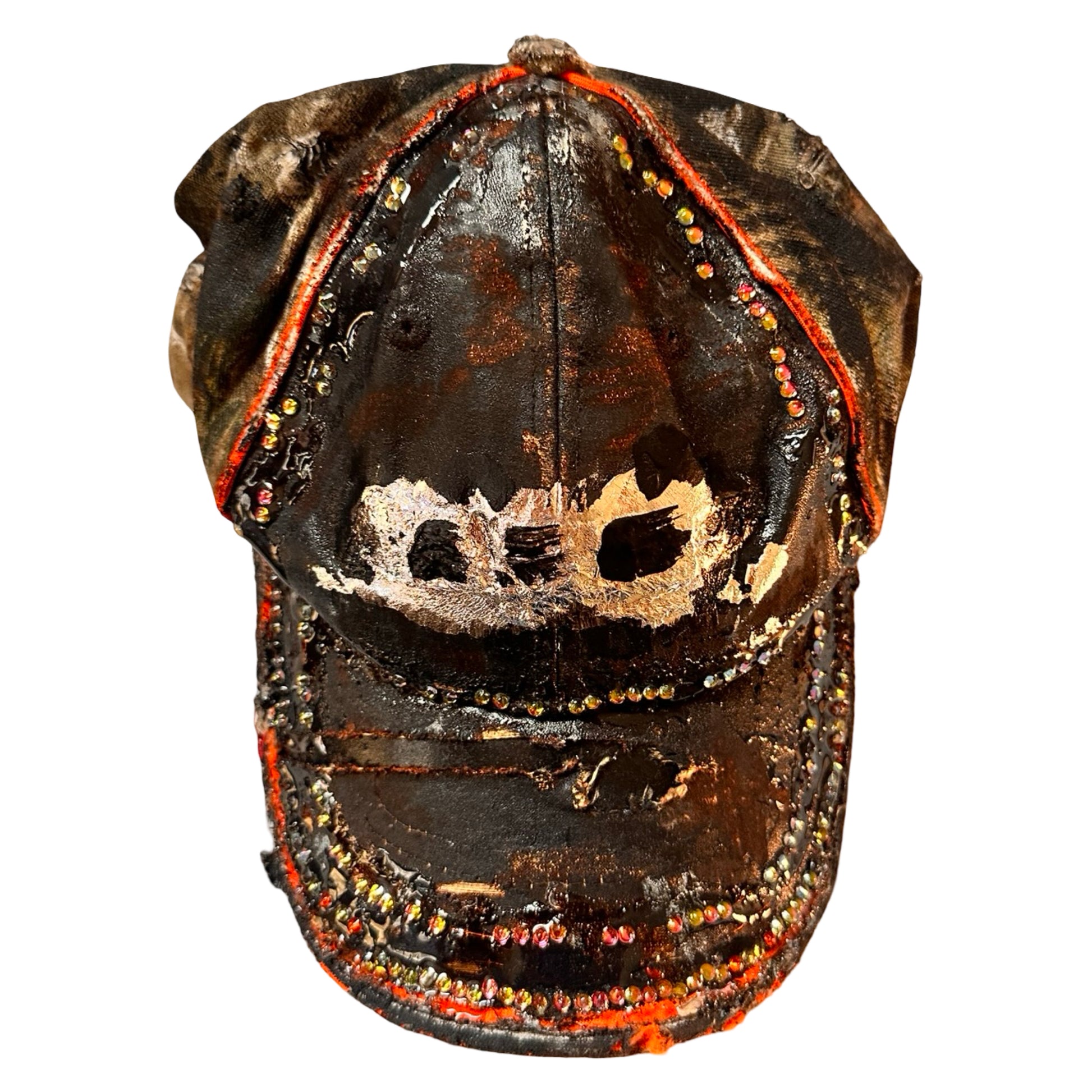 Flat front of ASTROBOI* brown camouflage distressed hat with rhinestones sealed in clear resin and custom hand-painted detailing.