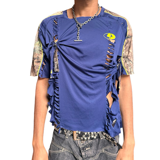 Person wearing a blue distressed t-shirt with camouflage sleeves on a white background
