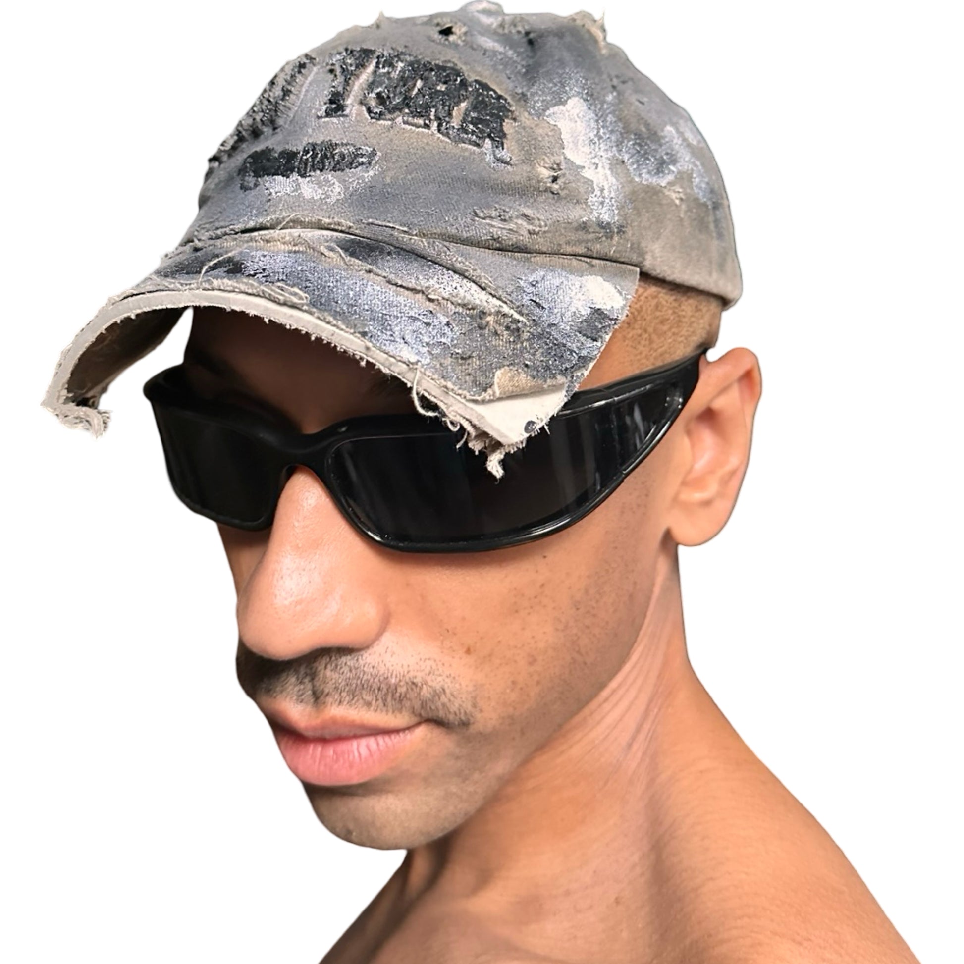 Front left view of ASTROBOI* tan and black New York logo hat with distressed half visor and black and white paint detailing.
