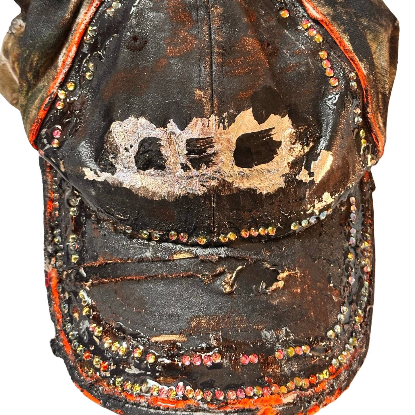 Flat front detail of ASTROBOI* brown camouflage distressed hat with rhinestones sealed in clear resin and custom hand-painted detailing.