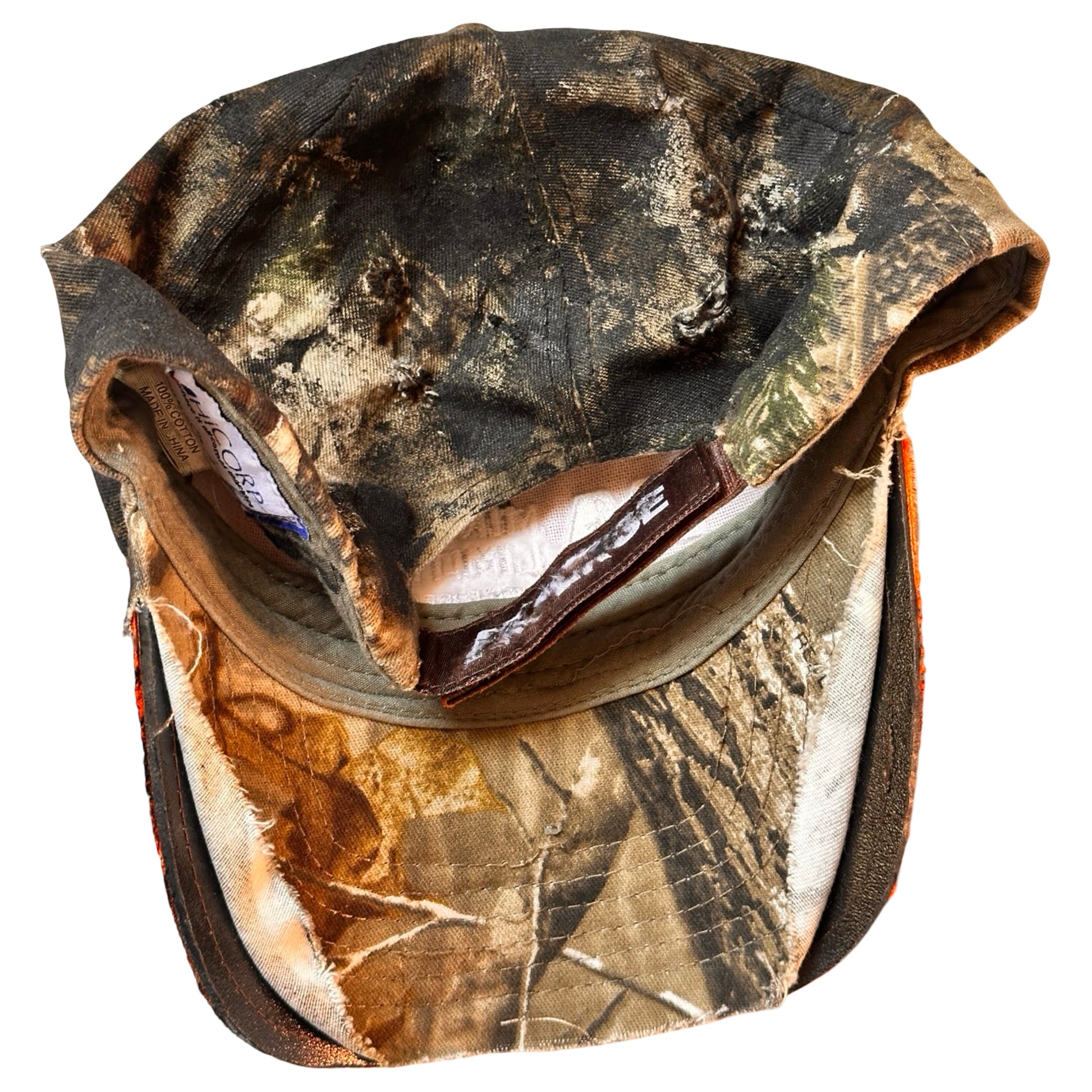 Flat back detail of ASTROBOI* brown camouflage distressed hat with rhinestones sealed in clear resin and custom hand-painted detailing.