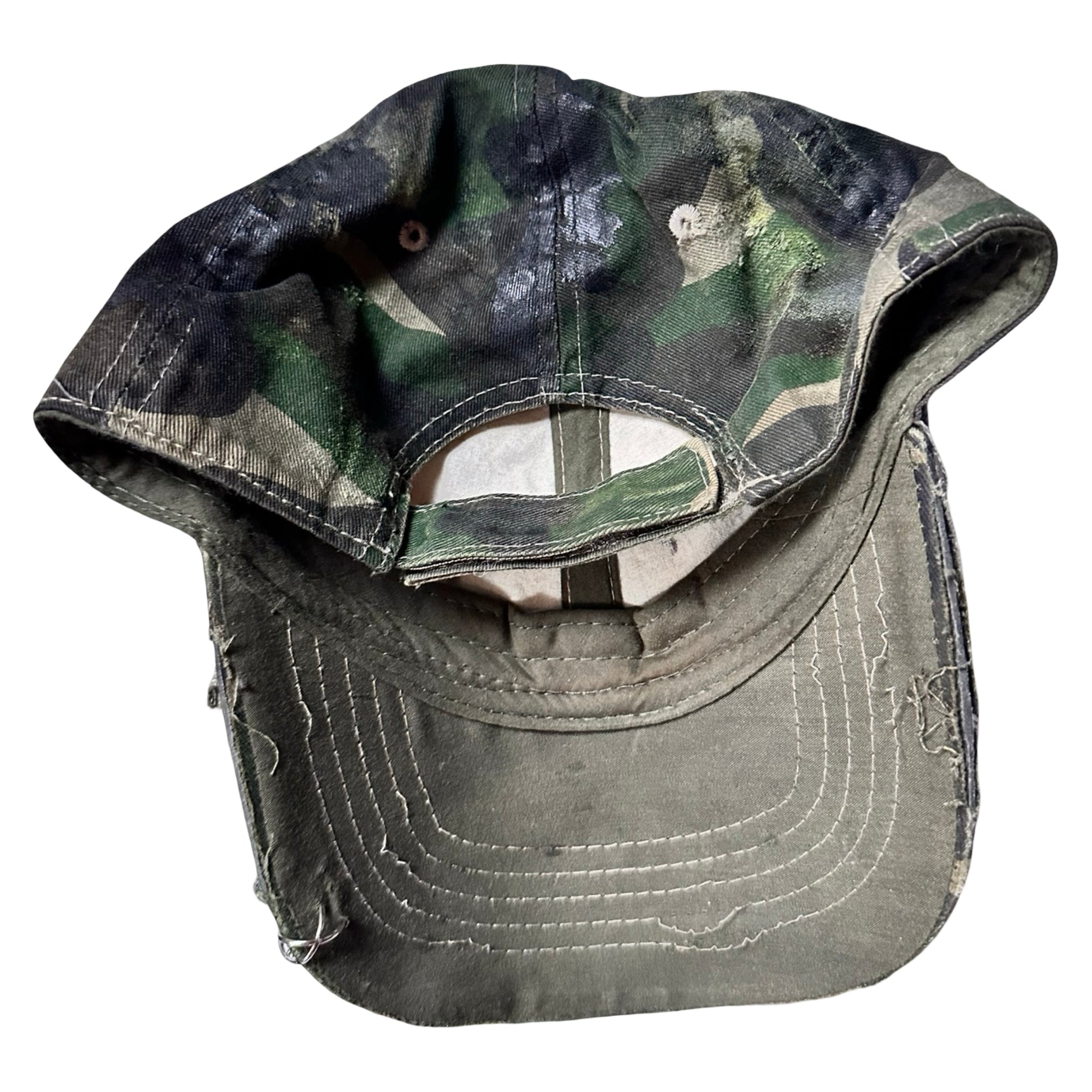 Back side of Green distressed hat with metallic rhinestones sealed in resin and stainless steel piercings, customized by ASTROBOI*.