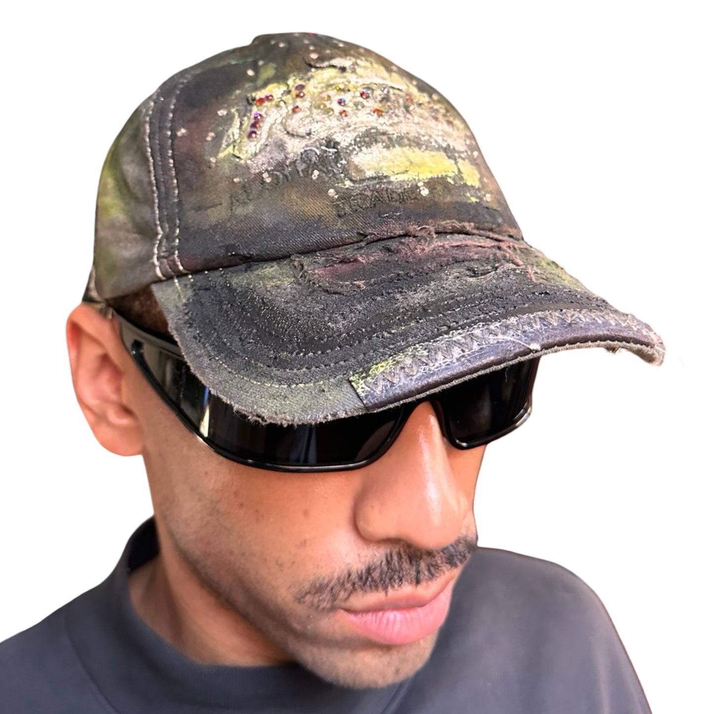 Front right image of “Green and brown distressed ASTROBOI* Hawaii hat with rhinestones, metallic paint, and sterling-steel piercings, customized in NYC.”