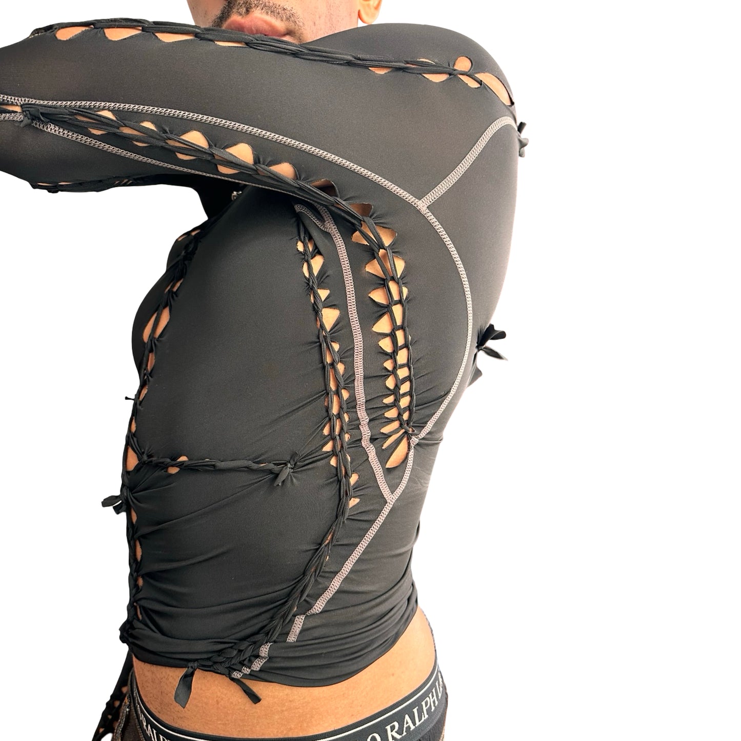 Right side detail of ASTROBOI* 'Mystique' black braided twist compression top with cut-out details. Handmade in NYC using breathable, moisture-wicking stretch fabric. 