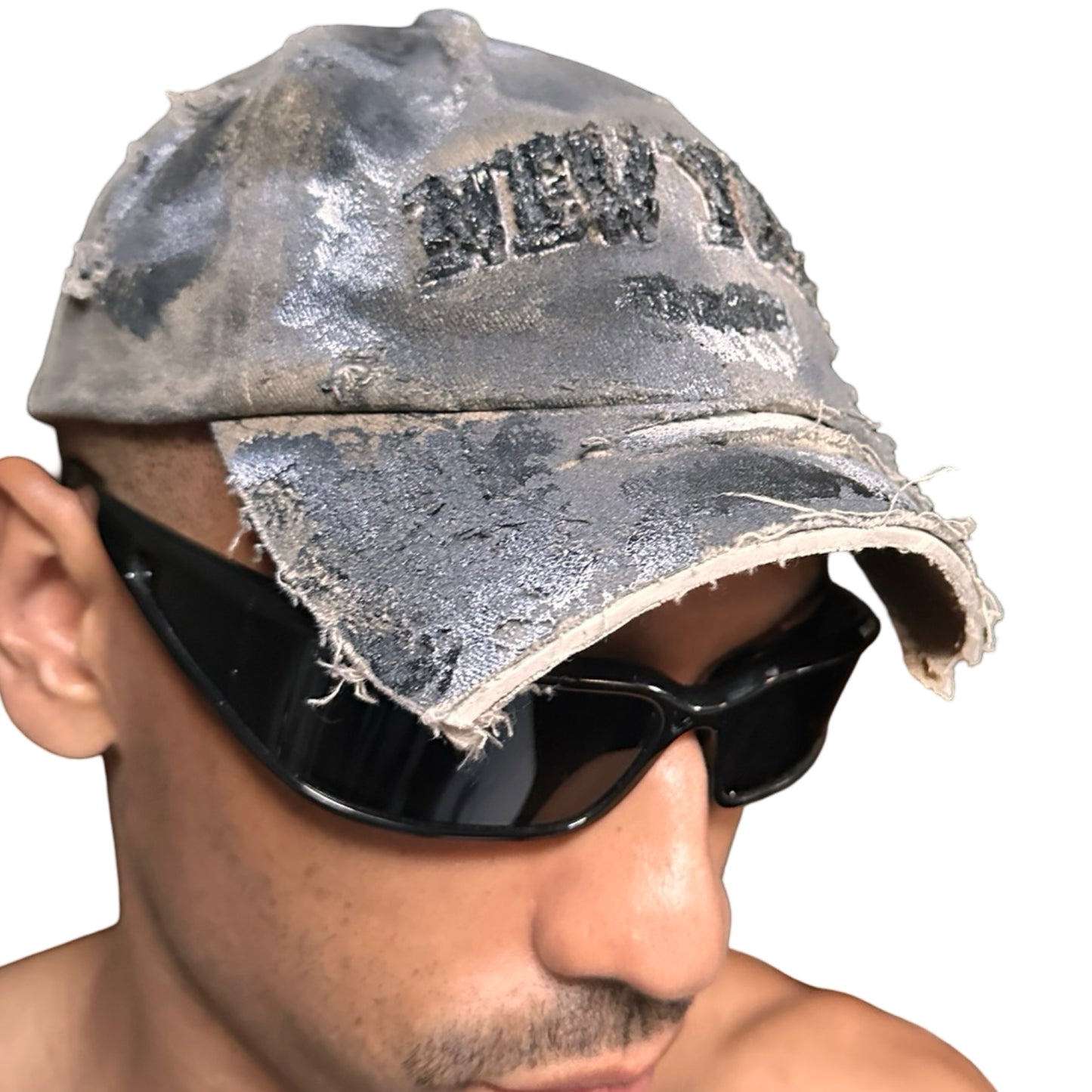 Front right view of ASTROBOI* tan and black New York logo hat with distressed half visor and black and white paint detailing.