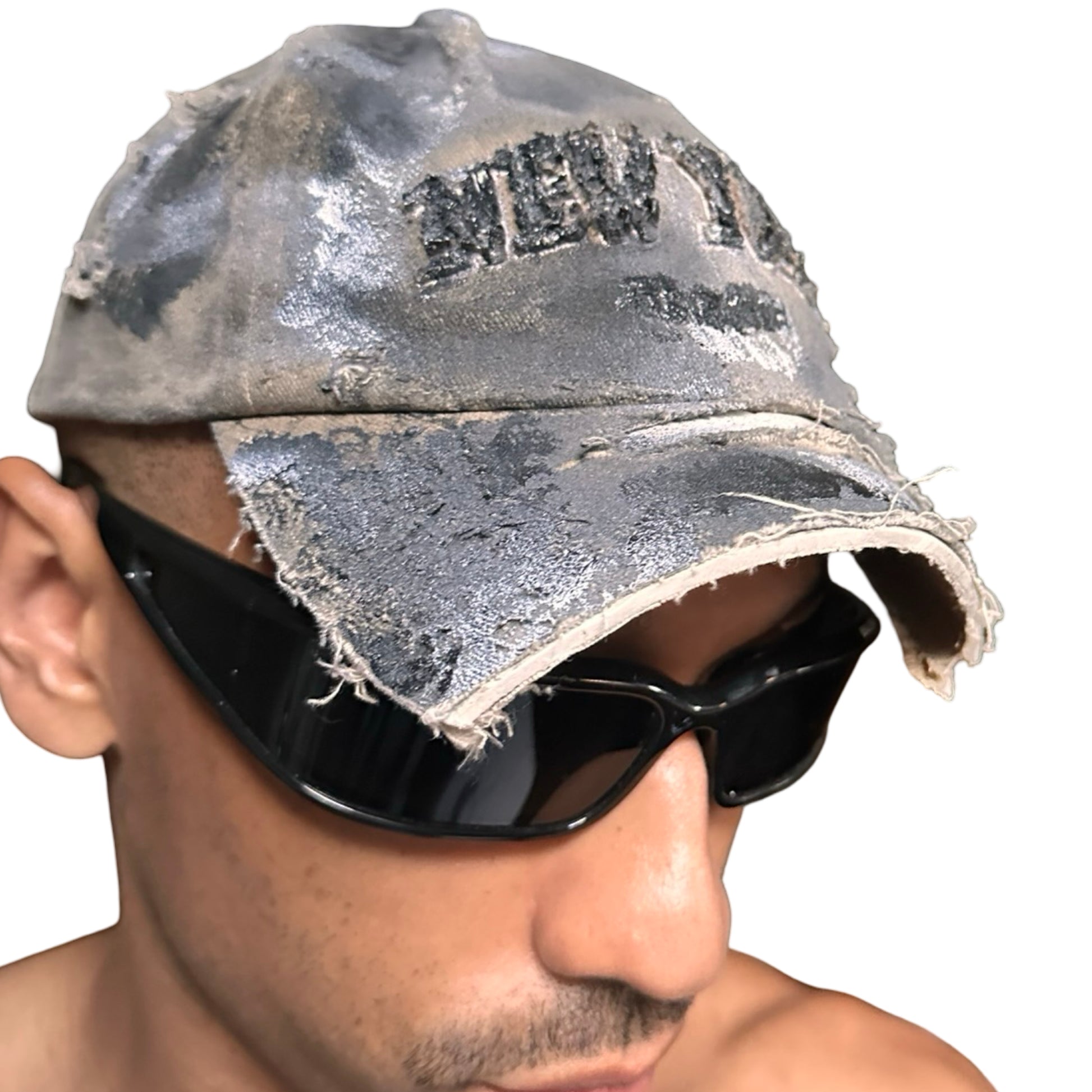 Front right view of ASTROBOI* tan and black New York logo hat with distressed half visor and black and white paint detailing.