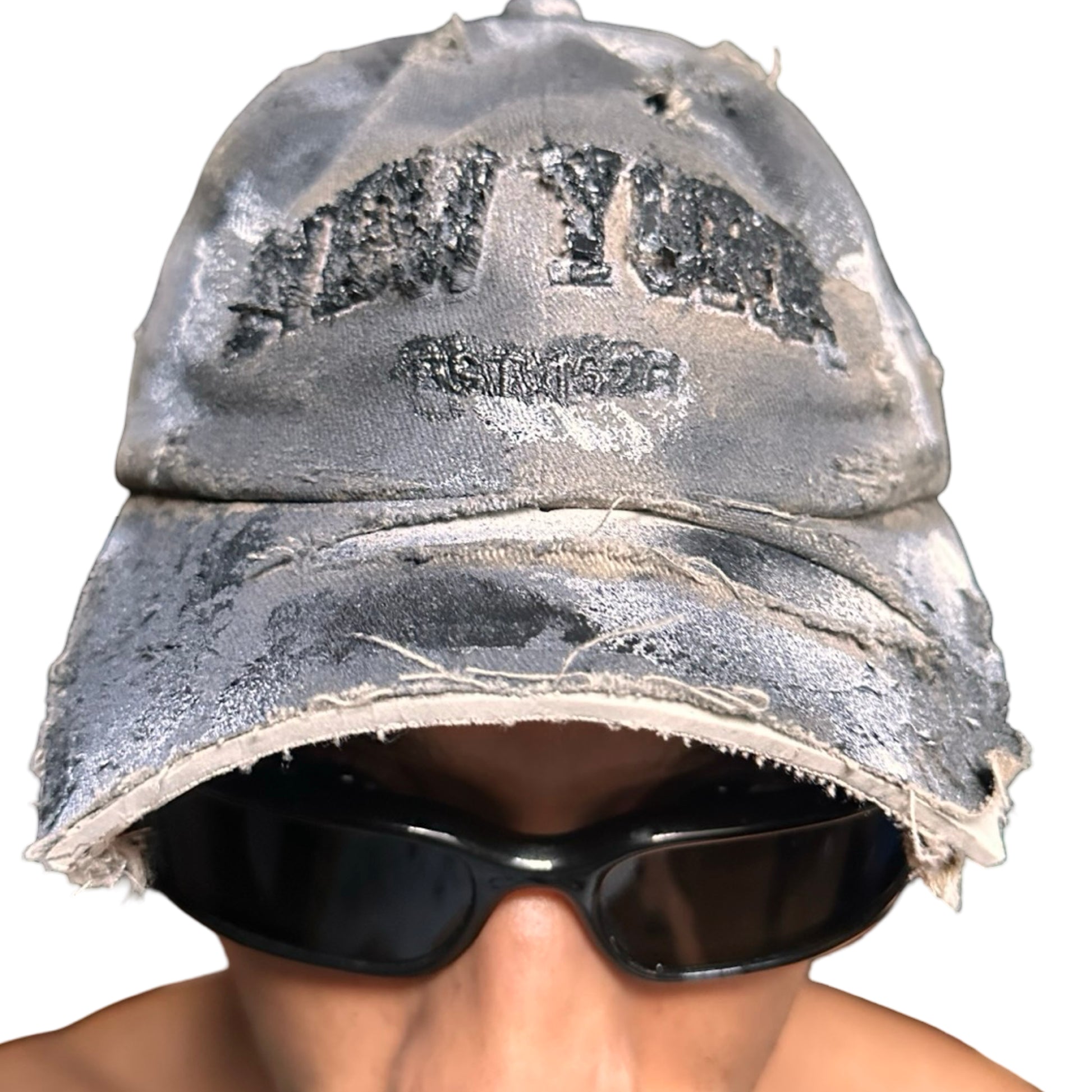 Front view on body of ASTROBOI* tan and black New York logo hat with distressed half visor and black and white paint detailing.