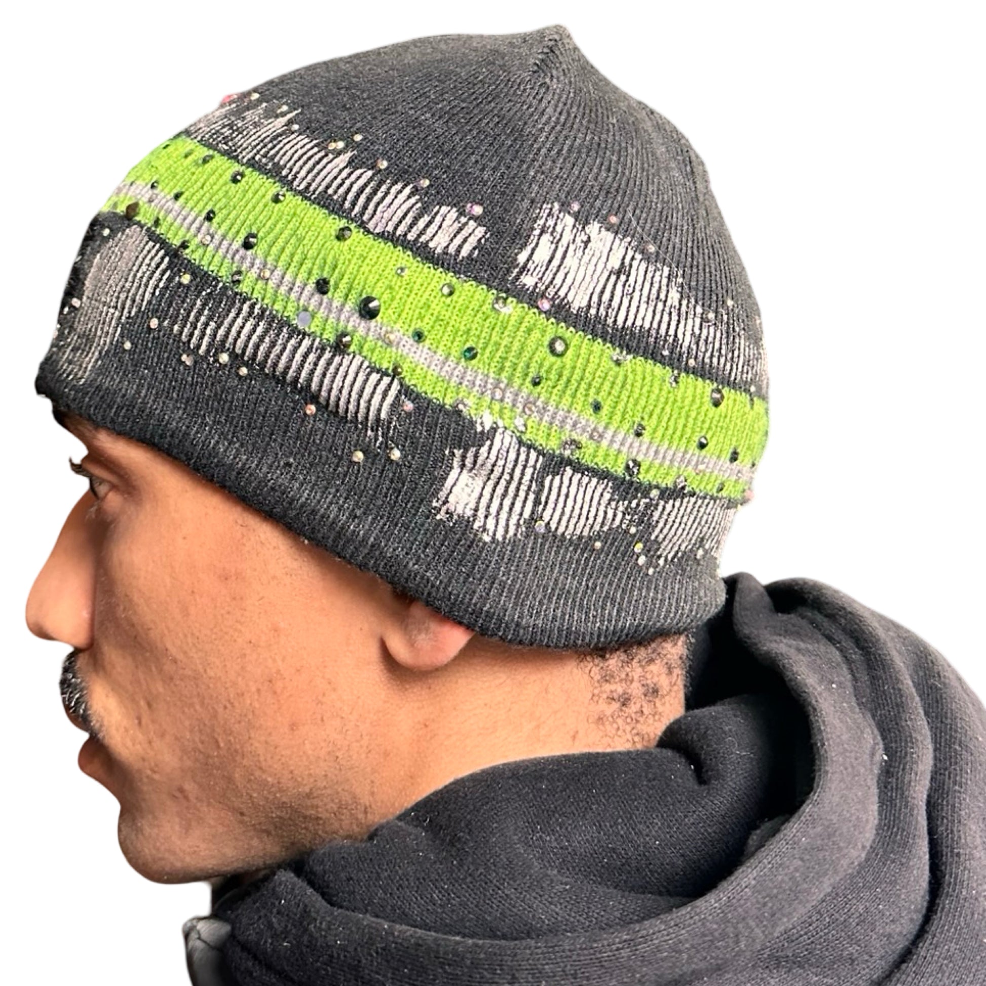 Left of ASTROBOI* grey beanie with slime green stripe, iridescent metallic paint, and multicolored rhinestones. Custom NYC-made Y2K streetwear accessory.