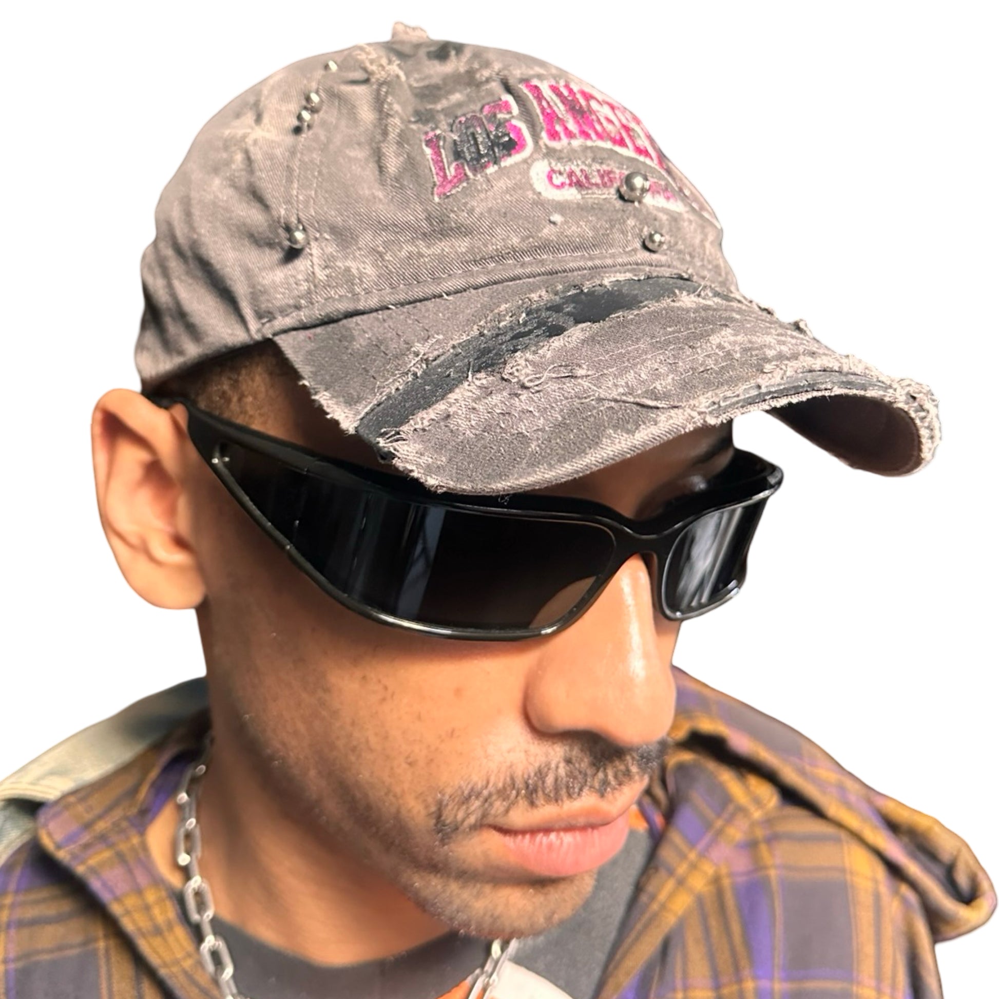 Front right side of Grey and pink distressed half-visor hat with ‘Los Angeles’ embroidery, black paint, and stainless steel piercings, customized by ASTROBOI*.