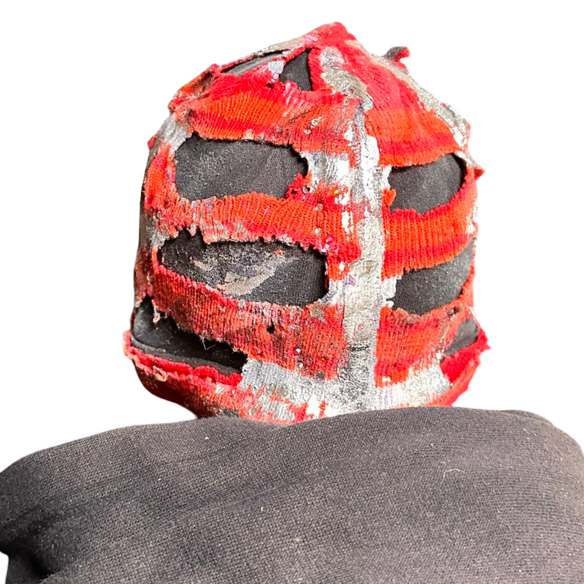 Back of ASTROBOI* orange and red striped beanie with cutouts, black fleece lining, rhinestones, and metallic paint. Distressed Y2K custom hat handmade in NYC.