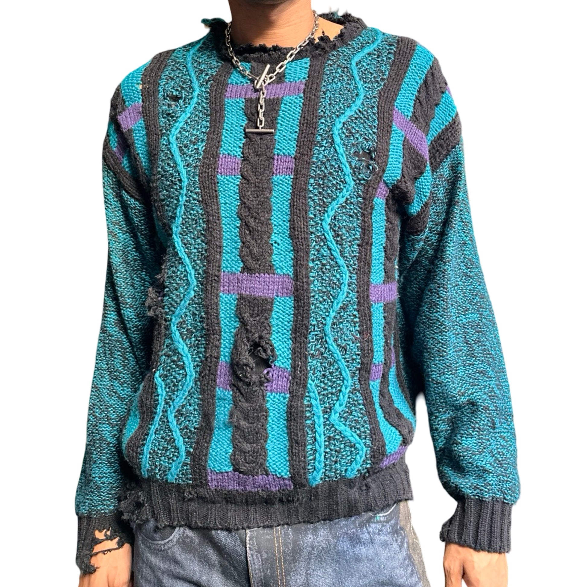 Person wearing a patterned sweater with blue, gray, and purple colors on a white background