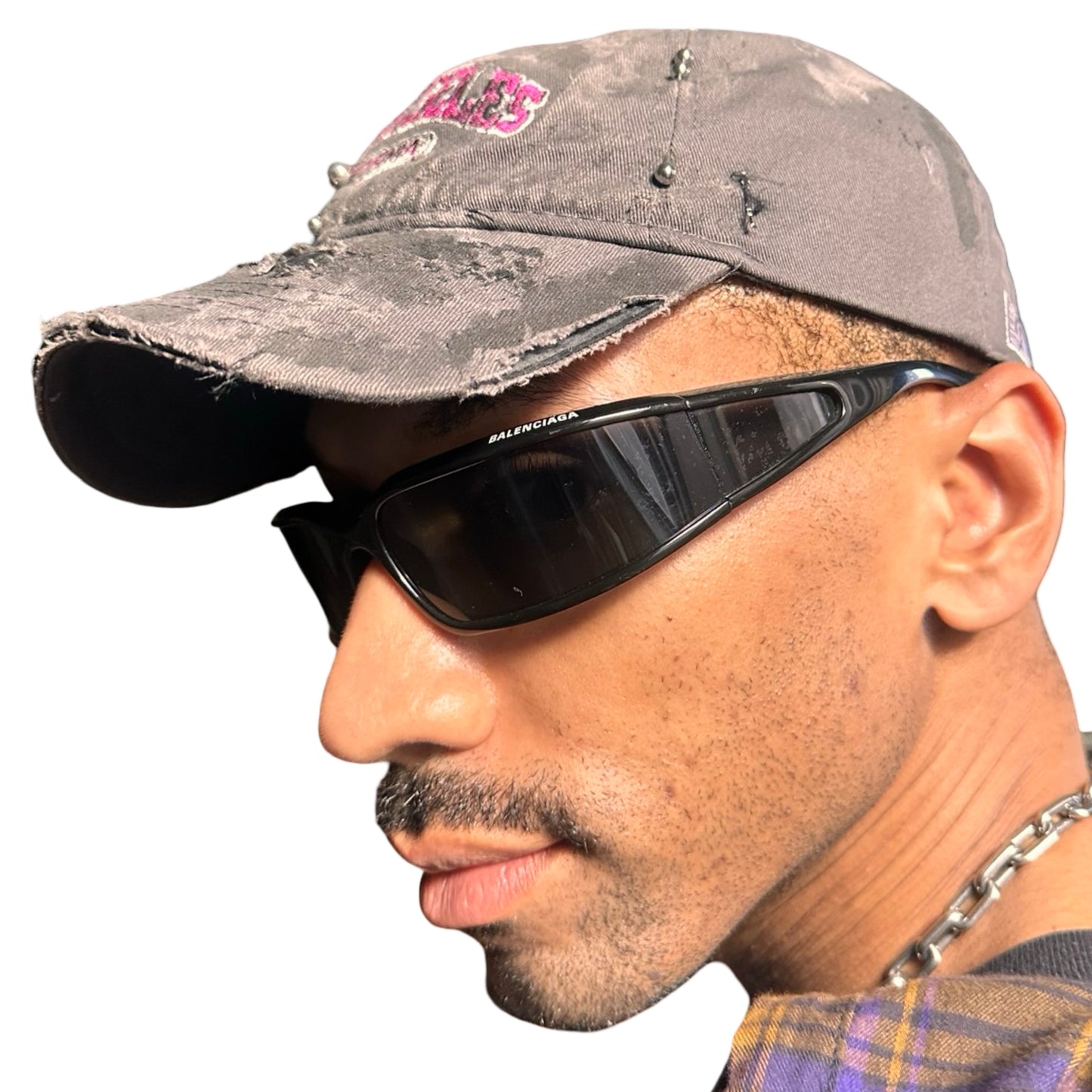 Left side of Grey and pink distressed half-visor hat with ‘Los Angeles’ embroidery, black paint, and stainless steel piercings, customized by ASTROBOI*.