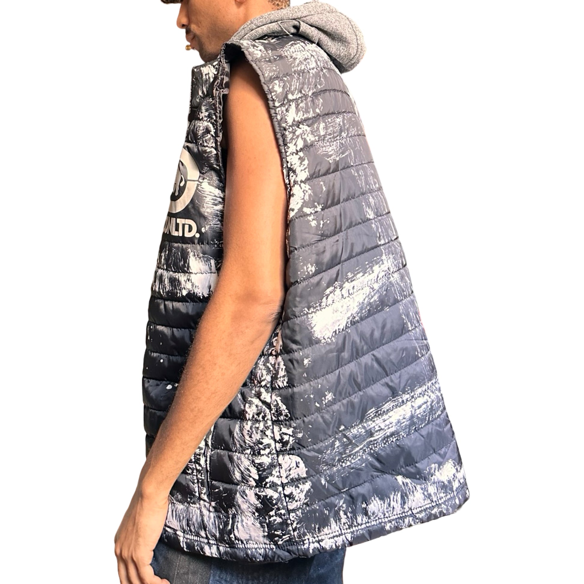 ASTROBOI* x Ecko Unltd black painted puffer vest with oversized gray hood, reflective logo, and white paint-stroke detailing. Custom streetwear made in NYC. Left side 