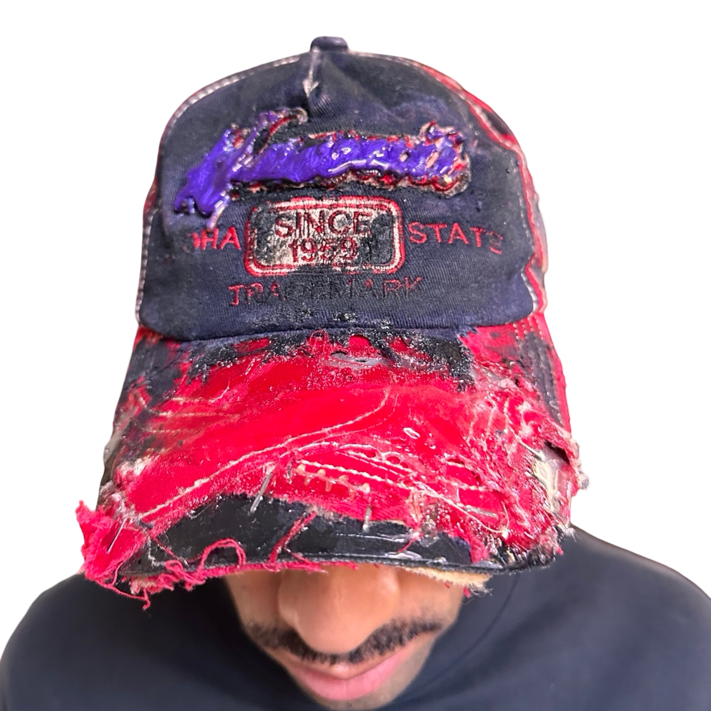 Front 2 of Blue and red ASTROBOI* hat featuring a purple resin-coated Hawaii graphic, deconstructed visor with clear resin, and black painted accents.