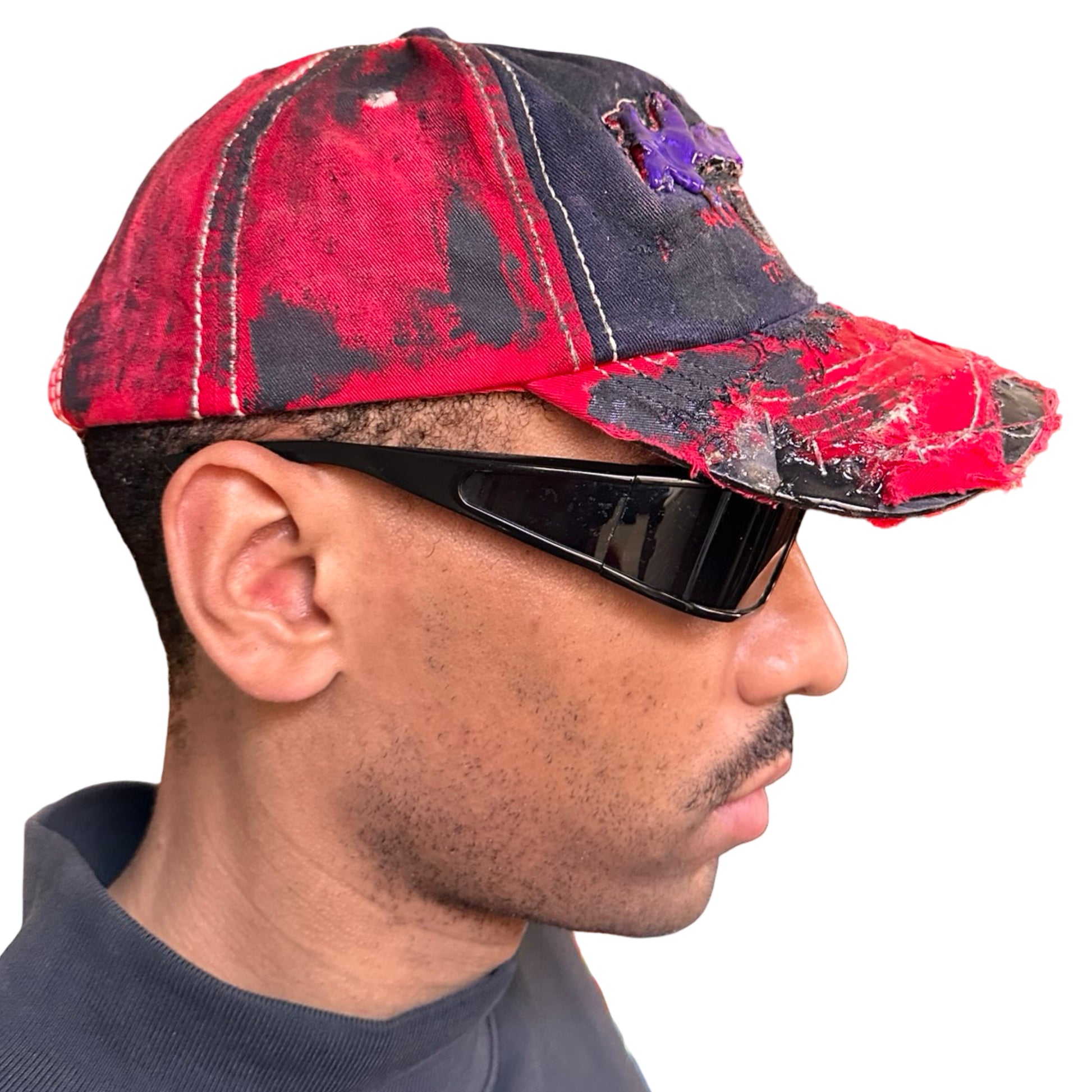 Right of Blue and red ASTROBOI* hat featuring a purple resin-coated Hawaii graphic, deconstructed visor with clear resin, and black painted accents.