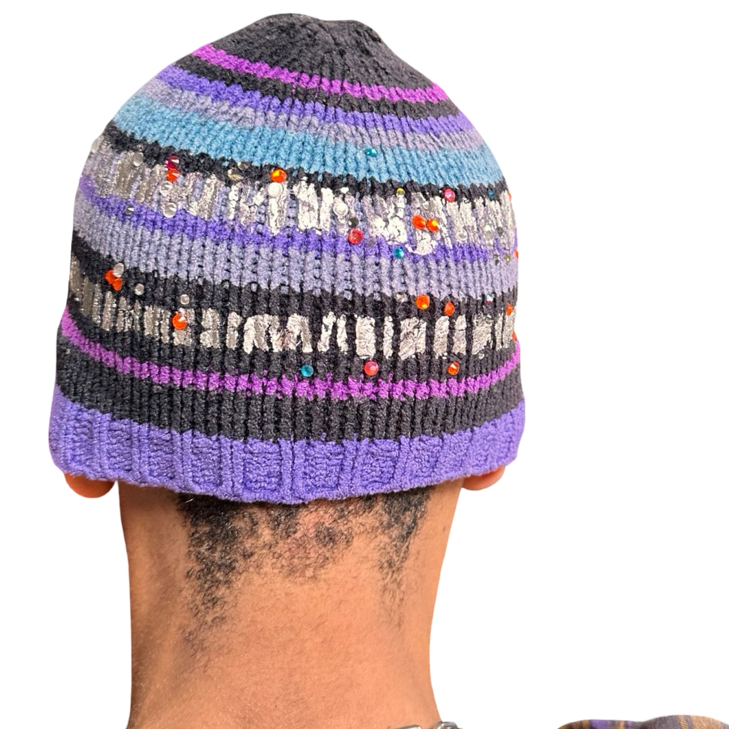 Back side of ASTROBOI* black and purple chenille striped beanie with silver detailing and orange rhinestones, handmade in NYC for a luxe streetwear finish.