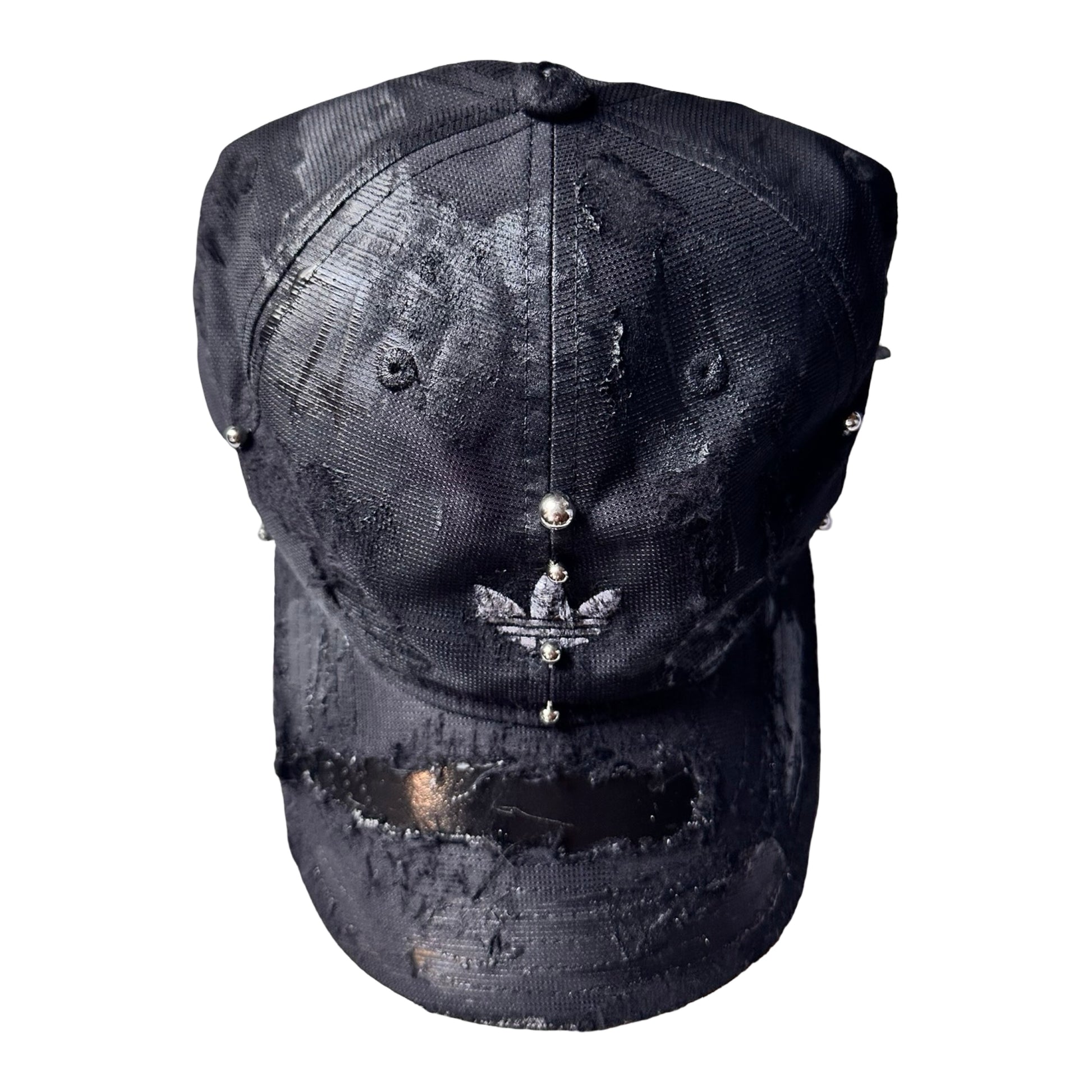 Front flat of Black Adidas hat customized by ASTROBOI* with distressing, black painted accents, and stainless steel piercings.