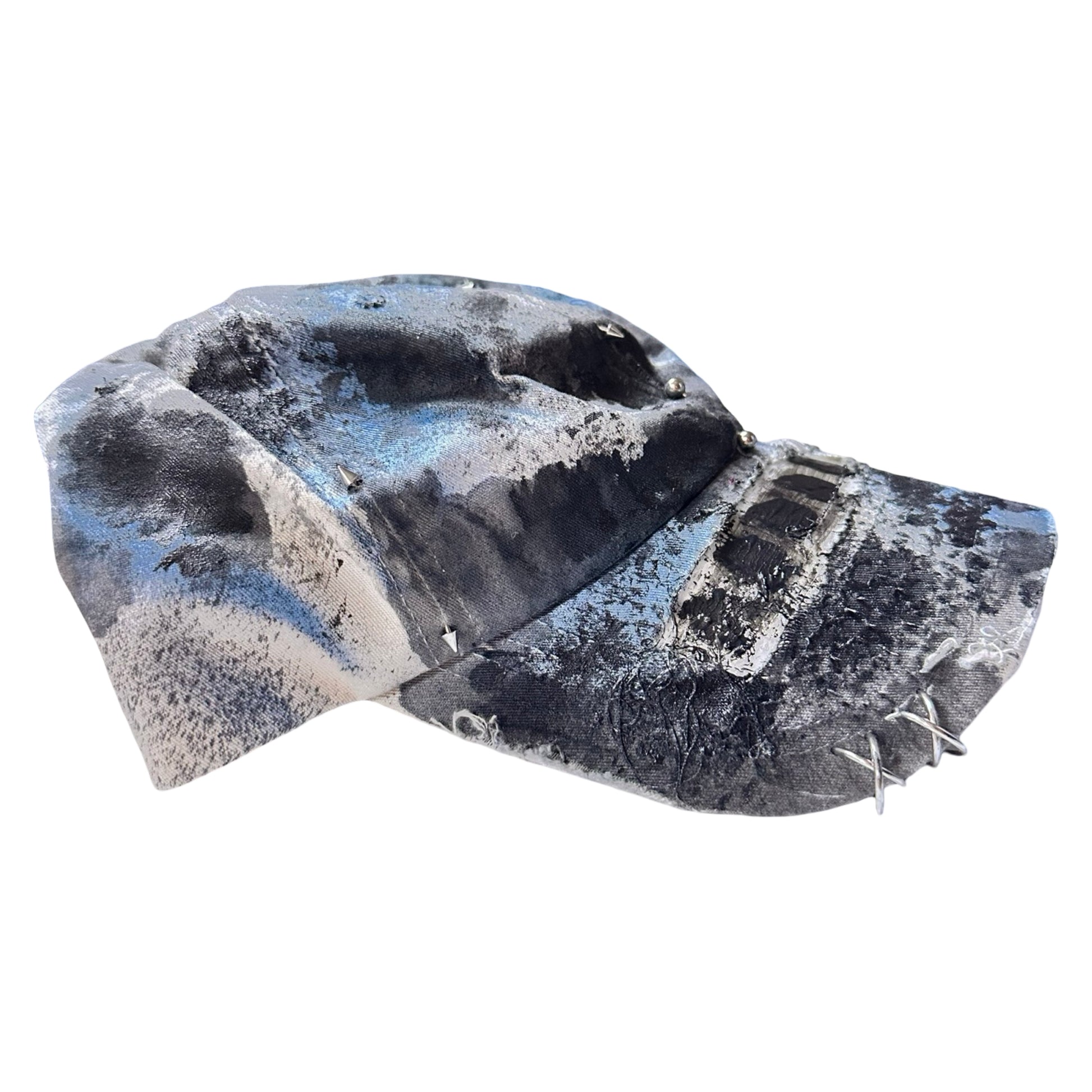 Flat right side of Black Vuori baseball hat customized by ASTROBOI* with blue and black painted details, stainless steel piercings, and an embroidered V logo.