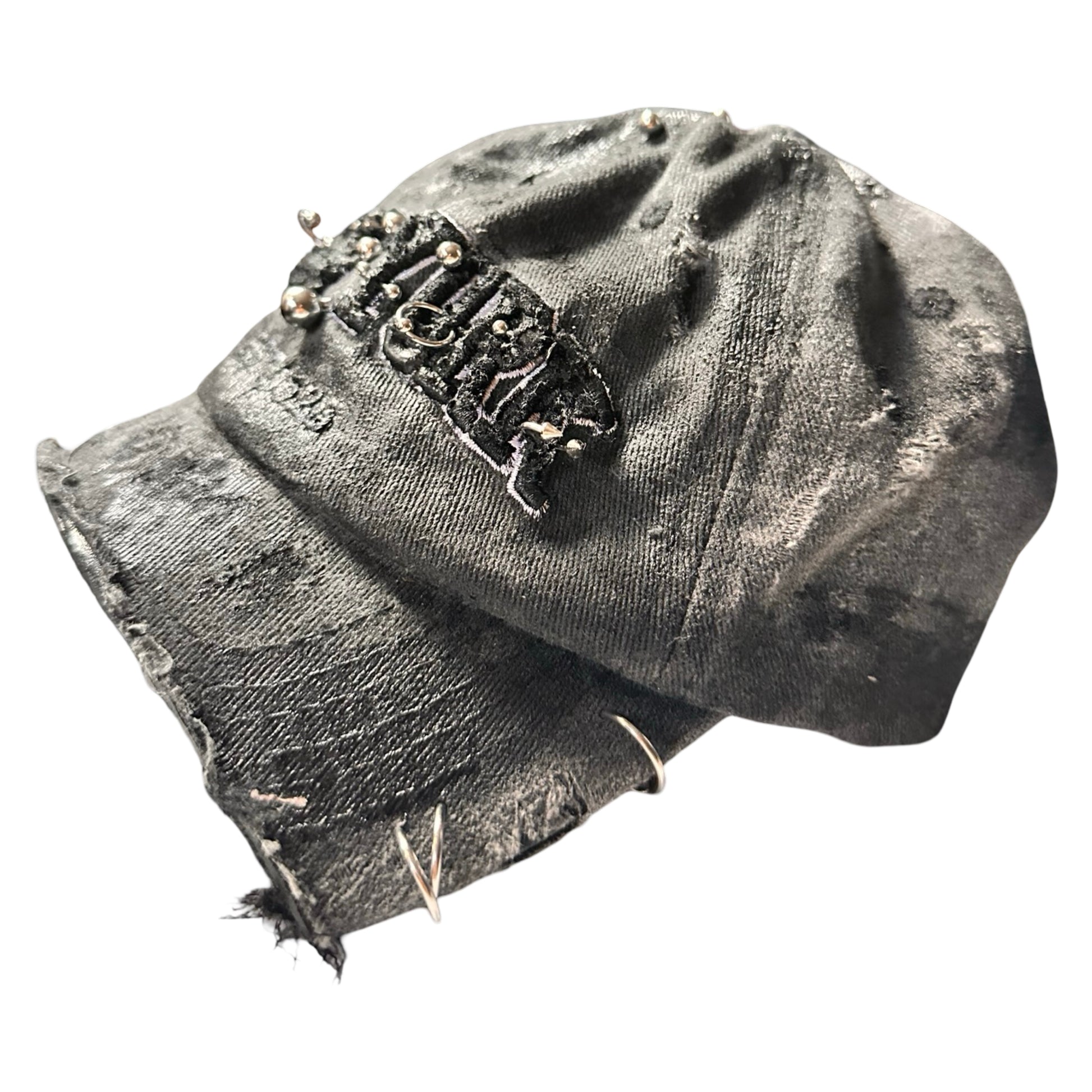 Flat left side of Black half-visor “New York” hat with embroidered front logo, stainless steel piercings, and an adjustable strap.