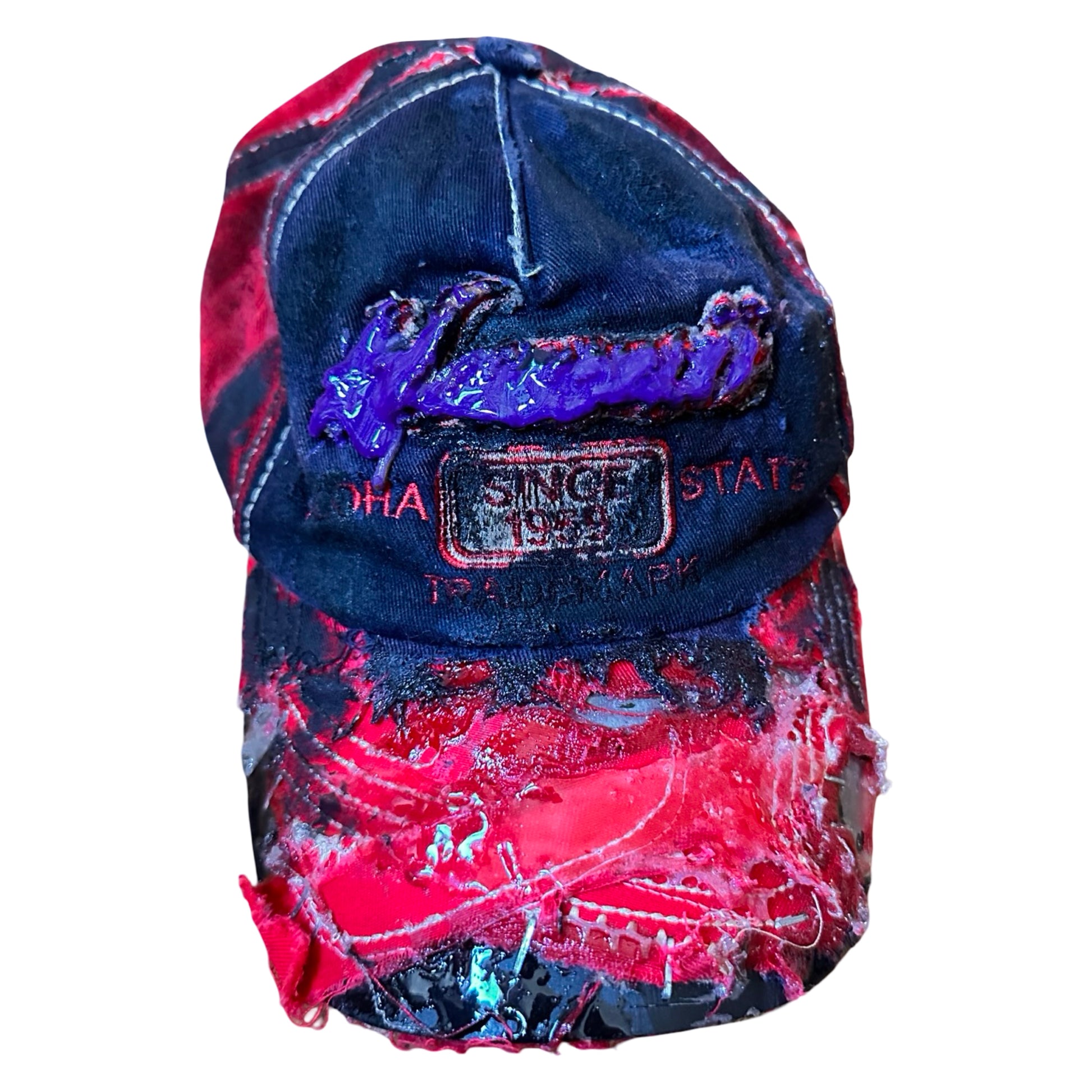 Flat lay of Blue and red ASTROBOI* hat featuring a purple resin-coated Hawaii graphic, deconstructed visor with clear resin, and black painted accents.