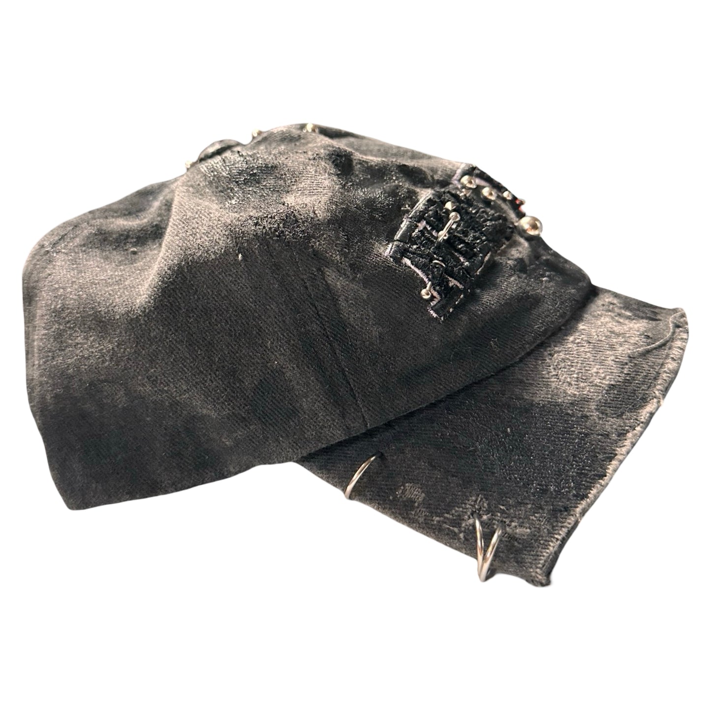 Flat right side of Black half-visor “New York” hat with embroidered front logo, stainless steel piercings, and an adjustable strap.