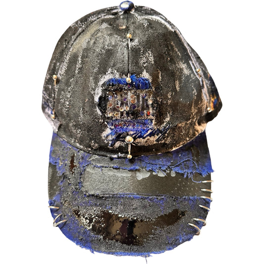 Flat front of Blue and white ASTROBOI* NAPA hat with rhinestone-covered logo sealed in clear resin, stainless steel piercings, and a deconstructed visor, handcrafted in NYC.